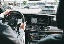 person in gray long sleeve shirt driving car