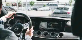 person in gray long sleeve shirt driving car