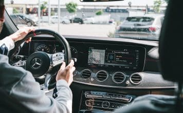 person in gray long sleeve shirt driving car