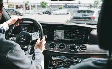 person in gray long sleeve shirt driving car