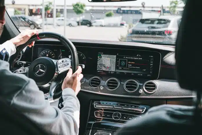 person in gray long sleeve shirt driving car