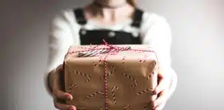 person showing brown gift box