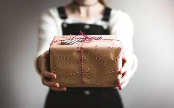 person showing brown gift box